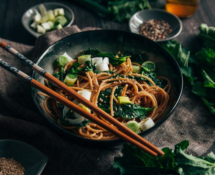 Soba noodles with turnip tops and sesame seeds Delicious and healthy noodles on dark background